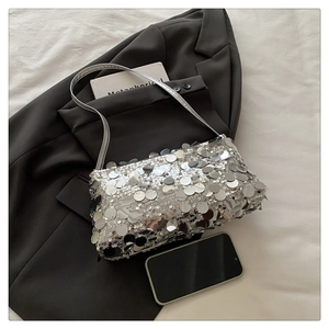Close-up of a silver sequined shoulder bag featuring metallic reflective large round sequins