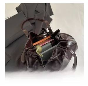 Top view showing the large storage capacity of a dark brown glossy leather tote bag