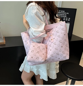 Pink swan print tote bag set with matching zippered pouch shown on a model