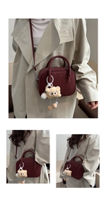 Detail of burgundy matte leather crossbody bag with beige plush eye charm decoration