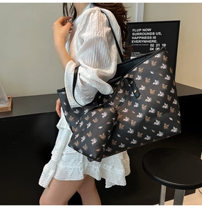 Detail of a black Pegasus print tote bag with a matching small pouch for women's daily use