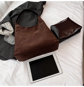 Detail of dark brown suede tote bag showing large capacity for tablet and cosmetics