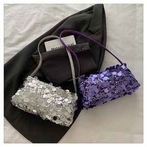 Detail of trendy silver and purple sequin shoulder bags on professional fashion backdrop