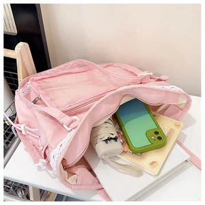 Interior detail of a pink lace tote bag showing capacity for umbrella and notebook