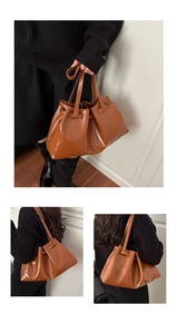 Detailed views of a brown glossy leather tote bag with stylish natural pleats and straps