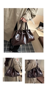 Detail of deep brown pleated tote bag with sleek oil wax finish and drawstring accents