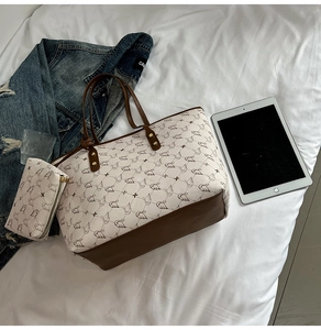 Detail of printed tote bag set with matching small zipper pouch on casual white fabric