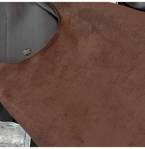 Macro detail of dark coffee frosted leather tote showing fine texture and precision stitching