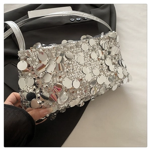 Close-up of silver sequin shoulder bag with metallic reflection and chain detail