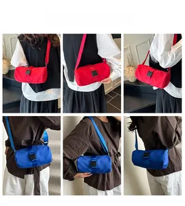 Detailed views of red and blue cylindrical travel crossbody bags with wide straps