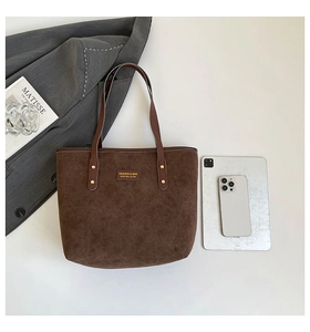 Top view of caramel suede tote bag with tablet showing large capacity and leather handles