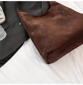 Macro detail of dark brown matte suede tote bag with soft texture and premium grain finish
