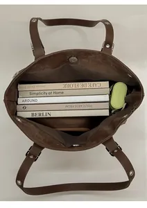 Top view of spacious brown leather tote bag interior showing large capacity for books