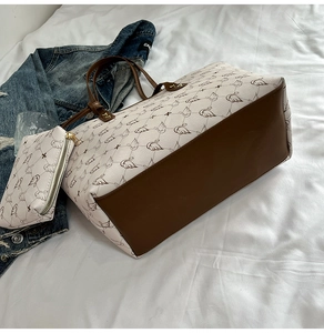 Detail view of printed tote bag set with swan patterns and matching small zipper pouch