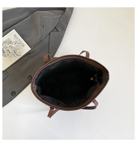 Top view showing the spacious interior with black fabric lining and a secure zipper pocket