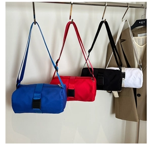 Detailed row of cylinder nylon sports bags in blue, red, black, and white colors