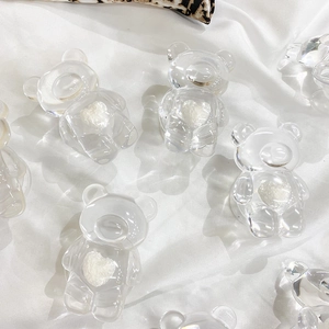Detailed view of clear acrylic bear phone grips with white textured heart inserts