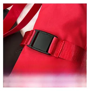 Detail of durable red Oxford fabric strap and black plastic adjustment buckle on shoulder bag
