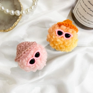 Detail showing cute plush doll phone sockets with sunglasses and small hats in pink and orange