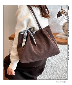 Brown faux suede tote bag with printed silk scarf detail shown in a modern setting