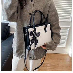 Detail of contrast tote bag with silk scarf handle and adjustable long strap