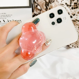 Detailed close-up of a pink translucent wave-shaped phone grip on a white smartphone