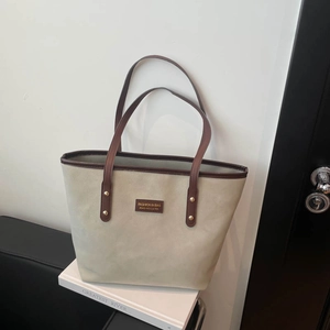 Large beige faux suede tote bag with brown leather trim for luxury office commuting