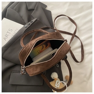 Interior view of brown suede retro handbag showing daily storage space and zipper