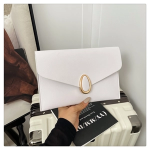 Detailed view of white Saffiano leather envelope clutch with elegant gold oval buckle