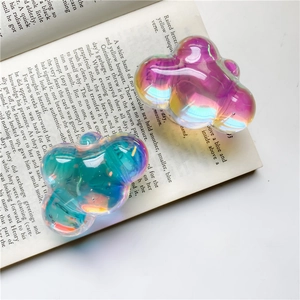 Detail showing two cloud-shaped iridescent phone grips on open book pages