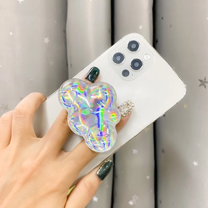 Detail of holographic laser cloud phone grip stand on a white smartphone back