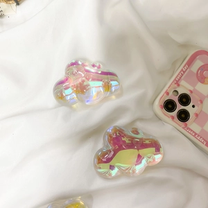Iridescent cloud phone stand with holographic finish shown on a white fabric background