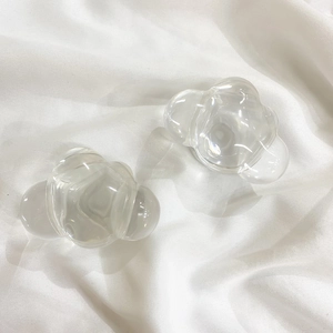 Macro shot of clear acrylic cloud-shaped grips on white textured background