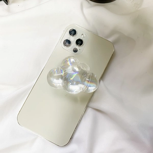Macro shot of iridescent cloud phone grip on gold smartphone with holographic effect