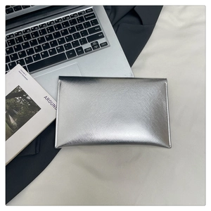 Detail of silver Saffiano cross-grain leather clutch bag with elegant metallic finish