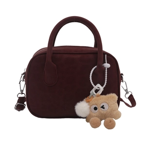Matte wine red Boston bag with top handles, crossbody strap and plush bear charm