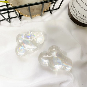 Detail view of two cloud-shaped acrylic phone grips with holographic iridescent finish