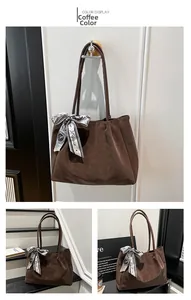 Detail of coffee brown tote bag with suede texture and decorative Paris scarf