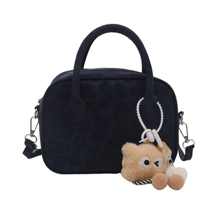 Retro dark blue leopard print Boston bag with dual handles and plush charm on white background