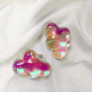 Detailed view of cloud-shaped phone holders with iridescent aurora resin finish