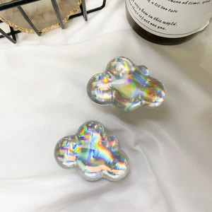 Detailed macro view of holographic acrylic cloud-shaped phone socket grips with rainbow finish
