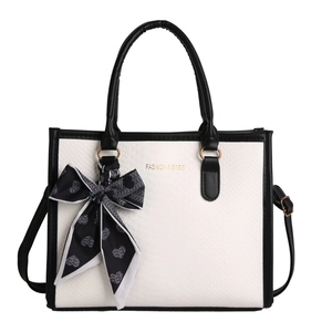 Contrast snake pattern handbag with heart print scarf and gold metal hardware detailing