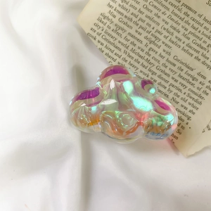 Macro shot of colorful cloud-shaped phone socket with holographic iridescent finish