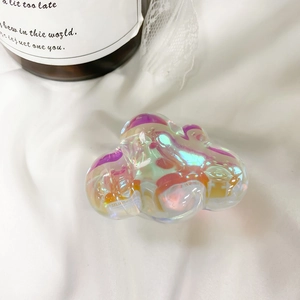Detailed macro shot of an iridescent cloud-shaped phone grip with a laser rainbow finish