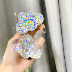 Macro detail of iridescent holographic cloud-shaped phone grip with rainbow resin finish