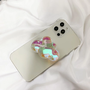 Macro view of cloud-shaped laser iridescent pop-up phone socket on white fabric