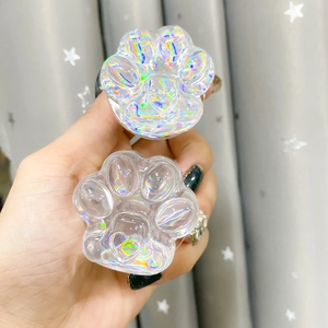 Close-up of iridescent cat paw phone socket holder with holographic heart detailing