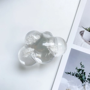 Detail of transparent cloud-shaped phone socket with artistic white fiber decoration inside