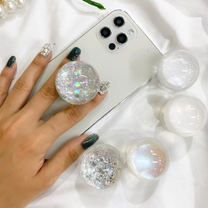 Detail of glitter planet phone grip showing iridescent silver foil and resin finish