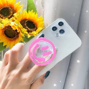 Close-up of pink smiley face telescopic phone socket with transparent adhesive base